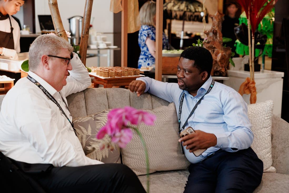 Segun Akande in conversation with a delegate